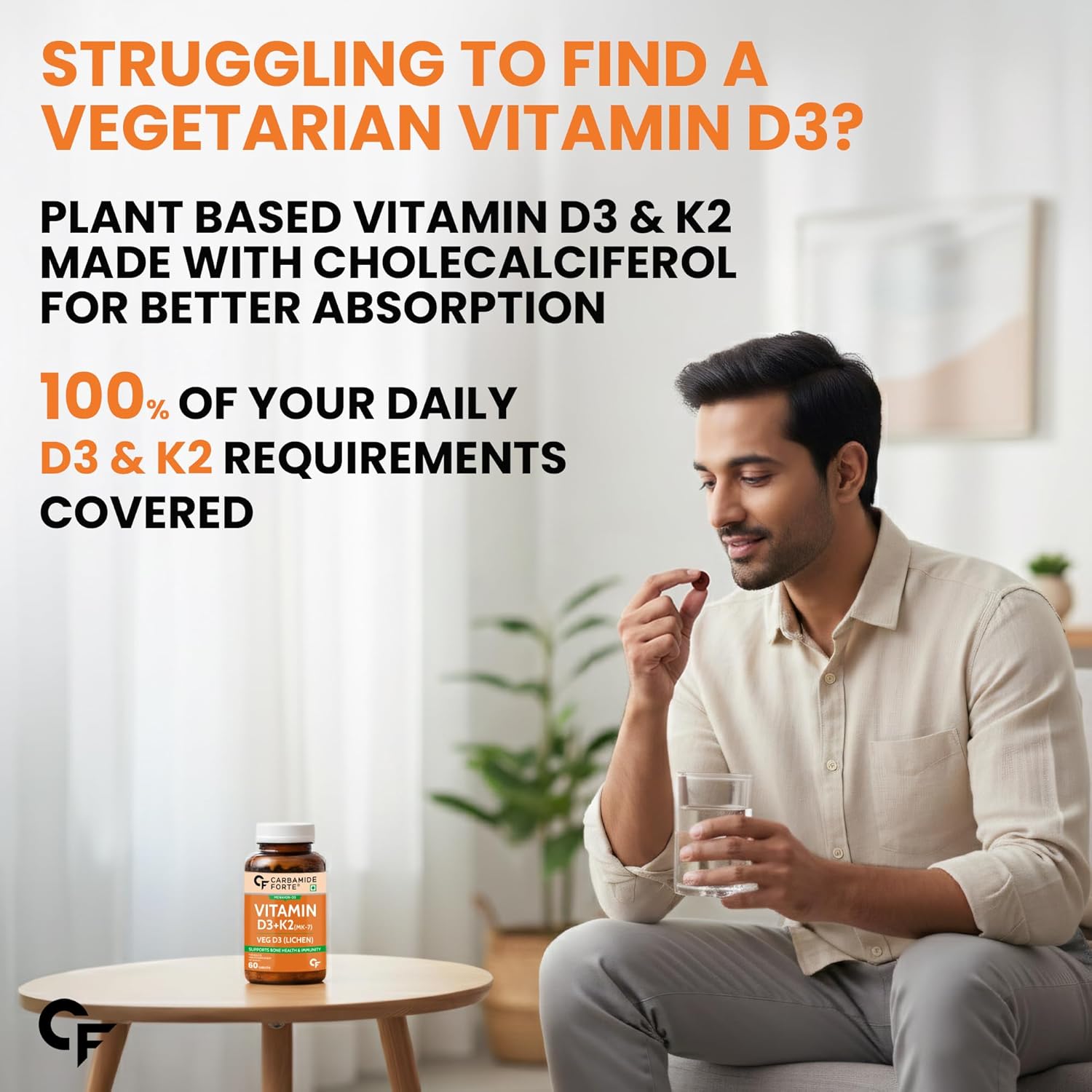 Man holding a glass of water with a bottle of vegetarian vitamin D3 and K2 supplement in a living room setting.