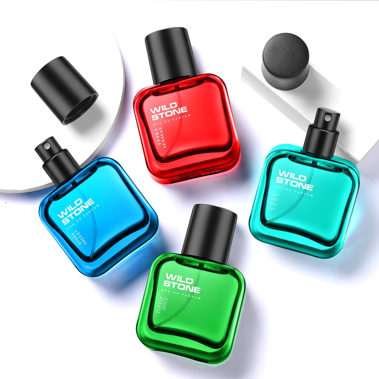 Five Wild Stone perfume bottles in red, blue, green, and black on a white background