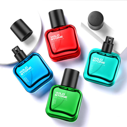 Five Wild Stone perfume bottles in red, blue, green, and black on a white background