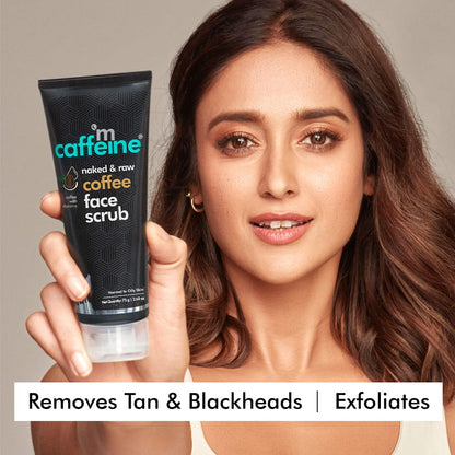 Woman holding a tube of 'm caffeine' coffee face scrub against a neutral background