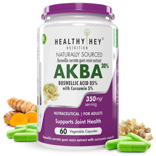 Container of Healthy Hey Nutrition AKBA supplement with capsules and turmeric on a white background