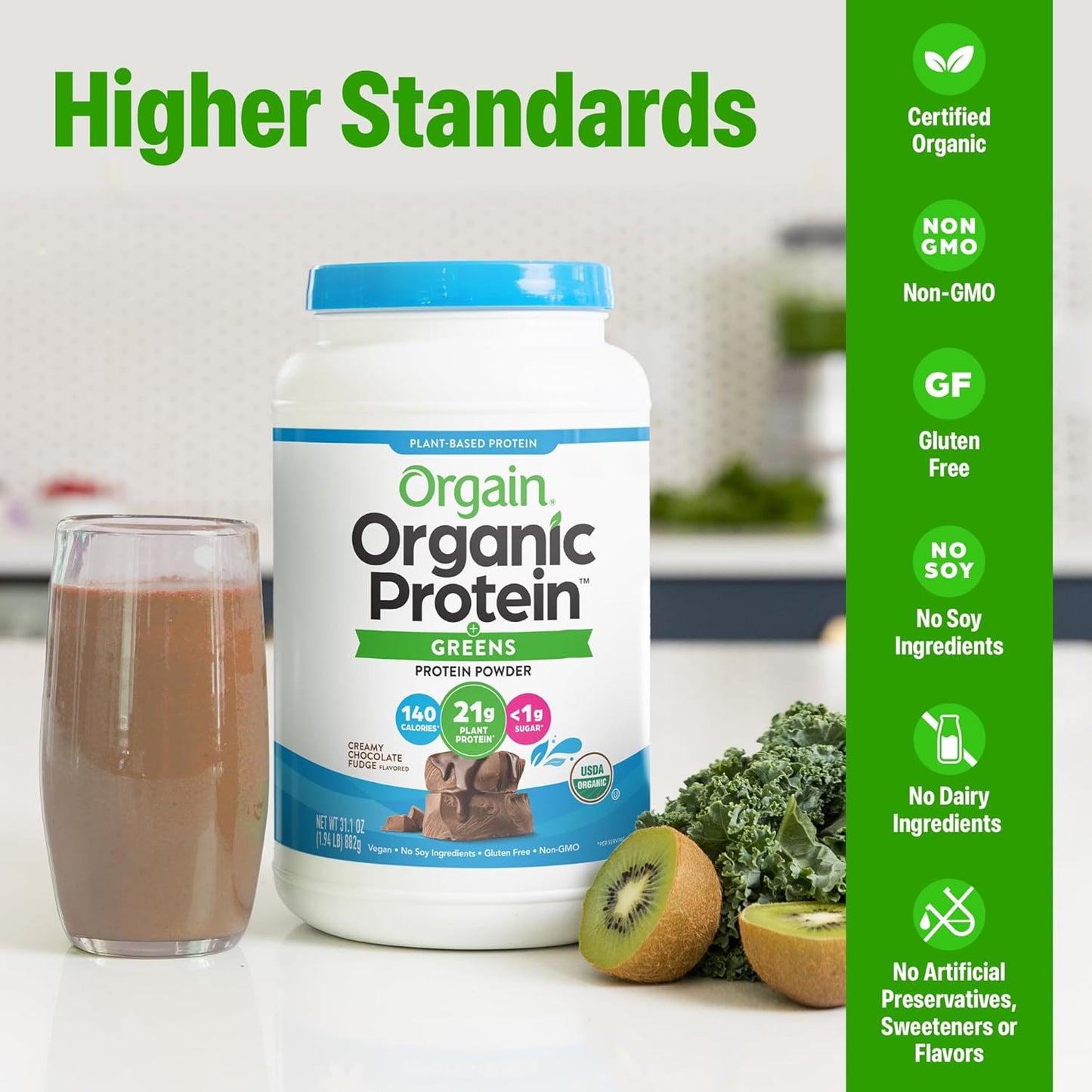 Orgain Organic Protein Greens powder container with a glass of chocolate shake and kiwi on a kitchen counter.