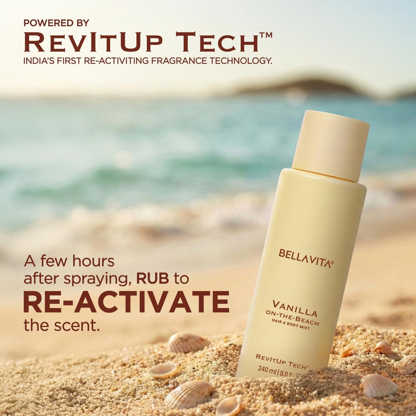 Bellavita Vanilla on-the-beach hair and body mist bottle on sand with ocean background, featuring RevitUp Tech.