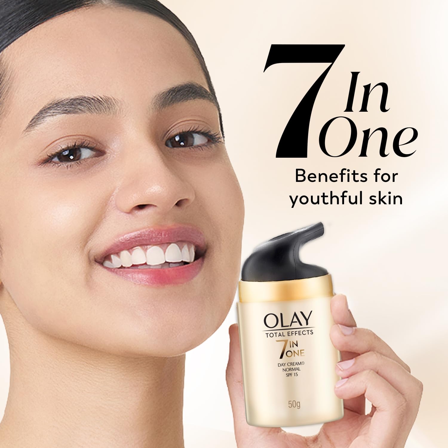 Olay Total Effects 7-in-1 Day Cream with a model holding it, on a beige background.