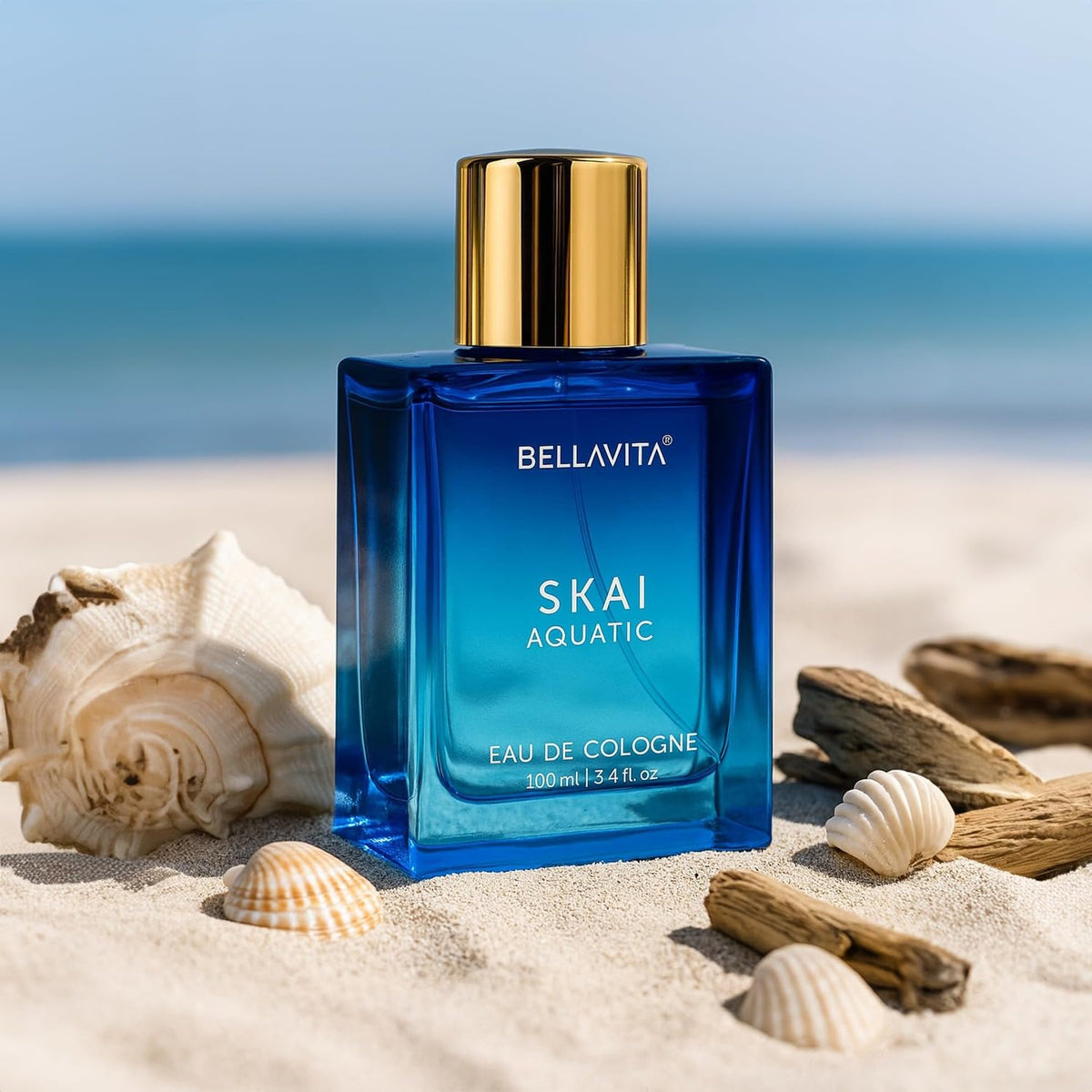Blue Bellavita Skai Aquatic cologne bottle on a sandy beach with shells and driftwood.