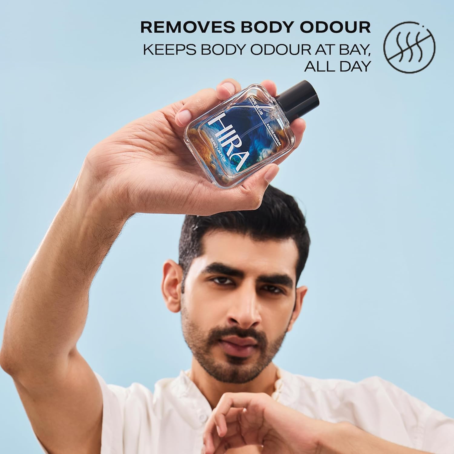 Person holding a bottle of HIRA product against a light blue background