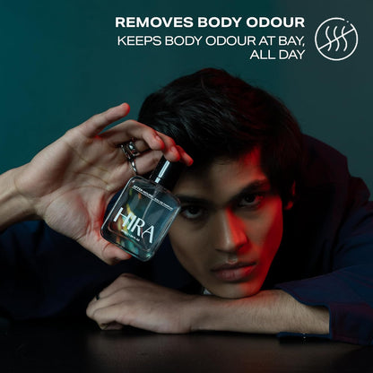 Person holding a HIRA perfume bottle with promotional text on a dark background