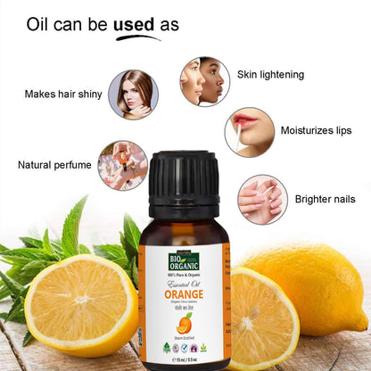 Bottle of orange essential oil with lemons and green leaves on a wooden surface, highlighting its uses.