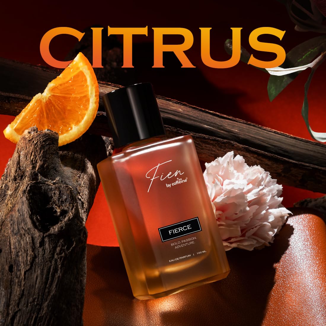 Perfume bottle labeled 'Fierce' by Fien with orange slices and a flower on a dark background.