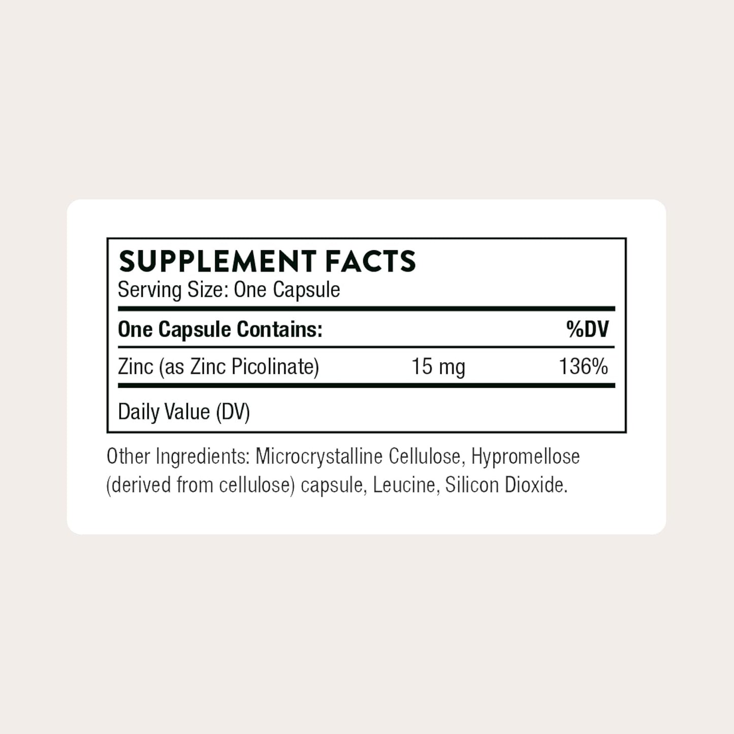 Supplement facts label for a zinc supplement capsule on a light beige background