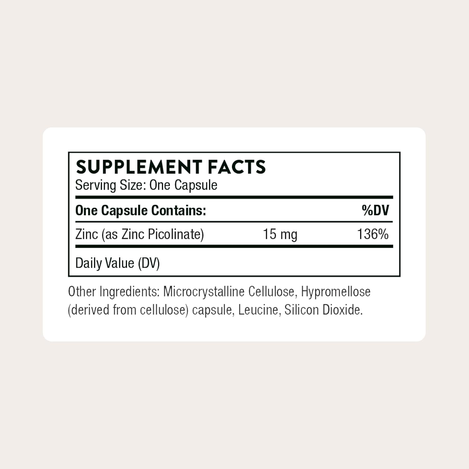 Supplement facts label for a zinc supplement capsule on a light beige background