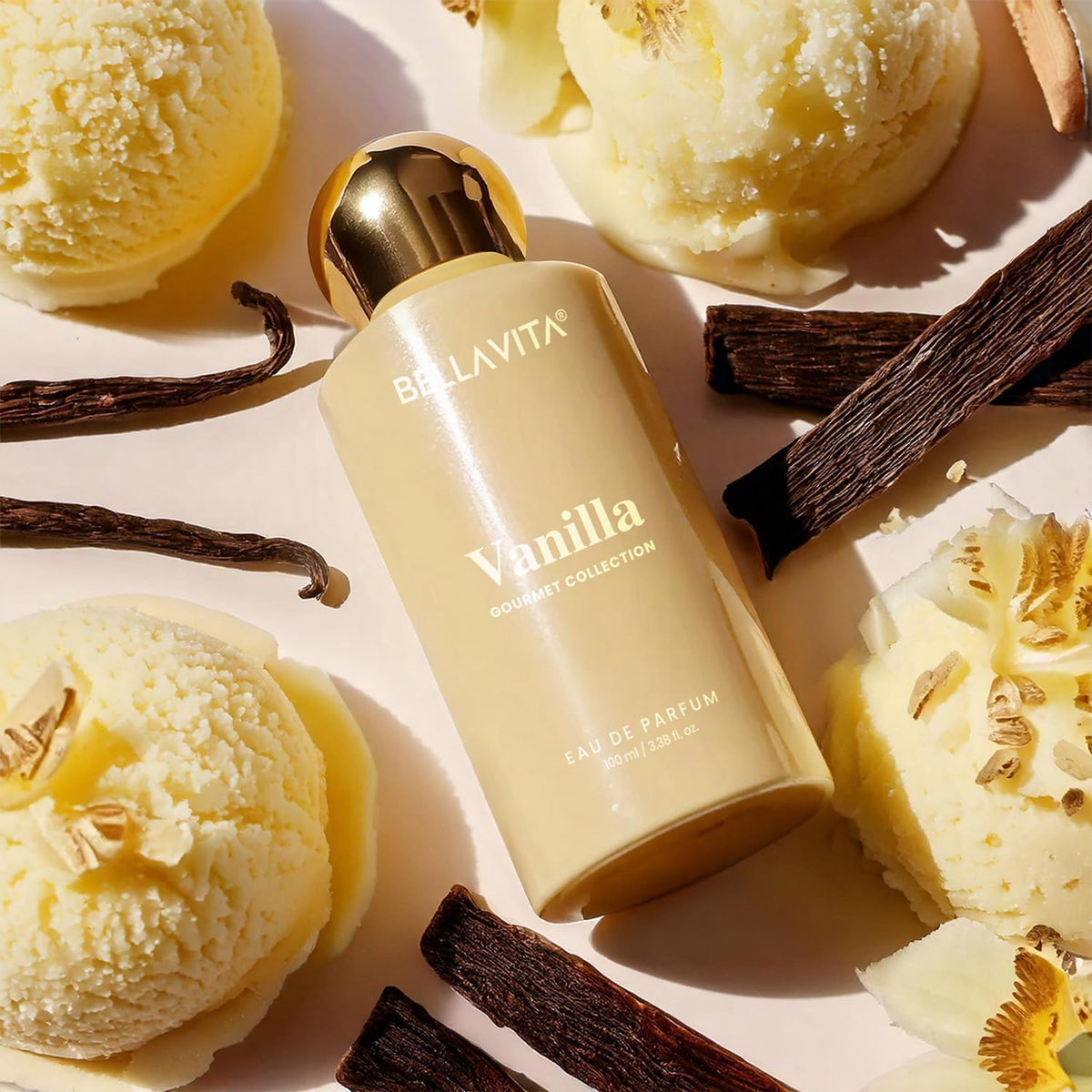 Bella Vita Vanilla perfume bottle surrounded by vanilla beans and ice cream on a light background