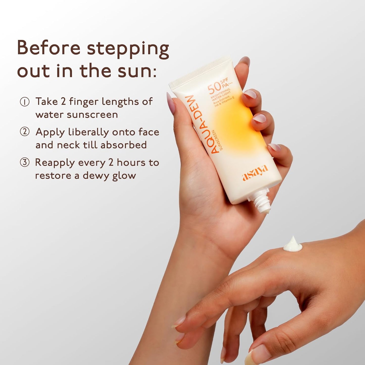 Hand applying sunscreen cream with text on a light gray background