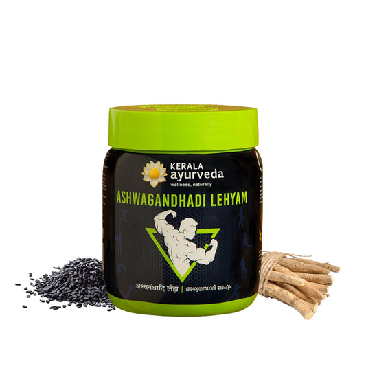 Jar of Kerala Ayurveda Ashwagandhadi Lehyam with a green lid and black body, surrounded by ashwagandha roots.