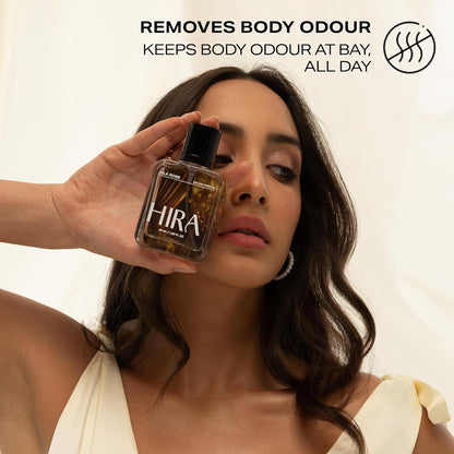Woman holding a bottle of HIRA with text about body odor removal.