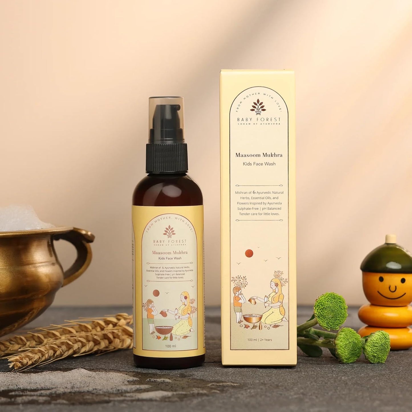 Bottle and box of Baby Forest Kids Face Wash on a textured surface with decorative elements.