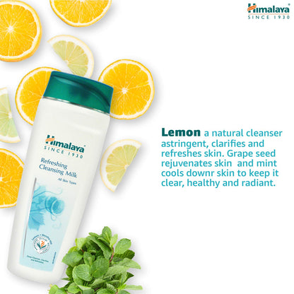 Himalaya Refreshing Cleansing Milk bottle with lemon slices and mint leaves on a white background