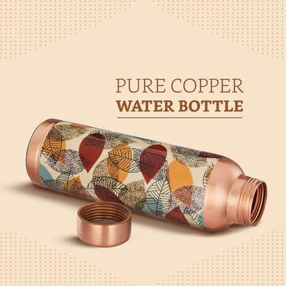 Copper water bottle with leaf pattern on a beige background