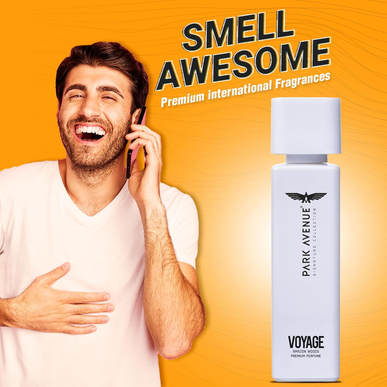 Man talking on phone with Park Avenue Voyage perfume bottle on an orange background