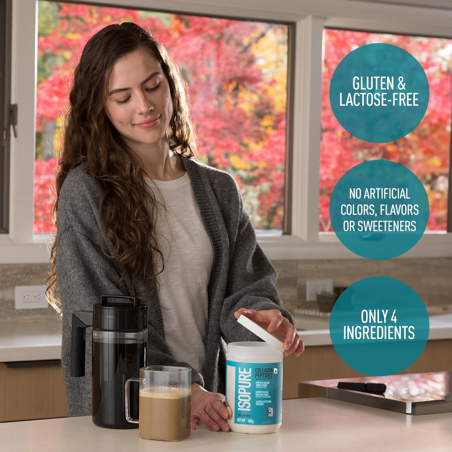 Woman preparing a drink with Isopure protein powder in a kitchen setting
