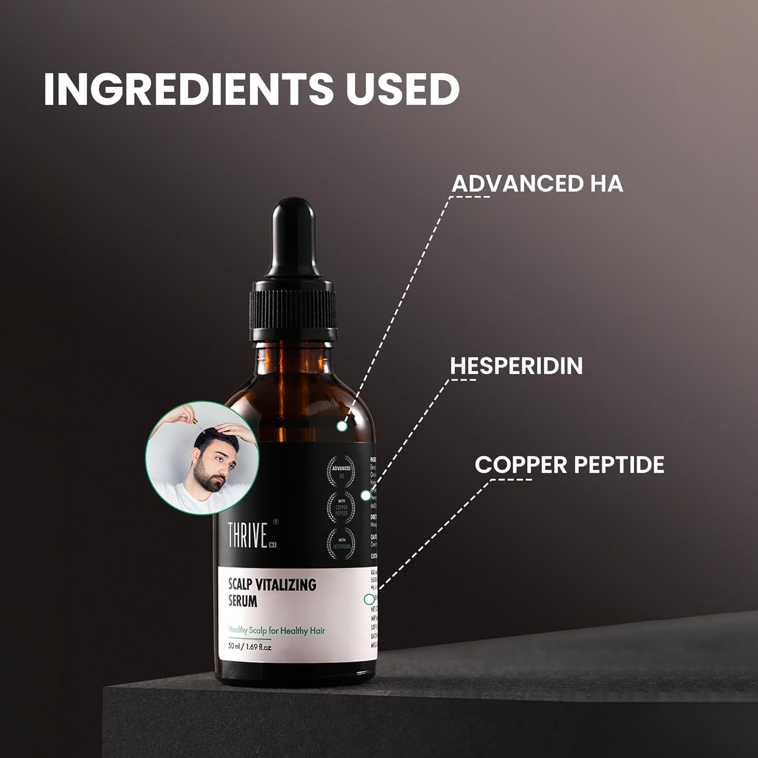 Bottle of scalp vitalizing serum with labeled ingredients on a dark background