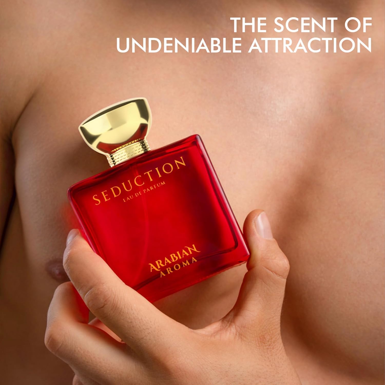 Red perfume bottle with gold cap held by a hand, against a blurred background with 'Seduction' text.