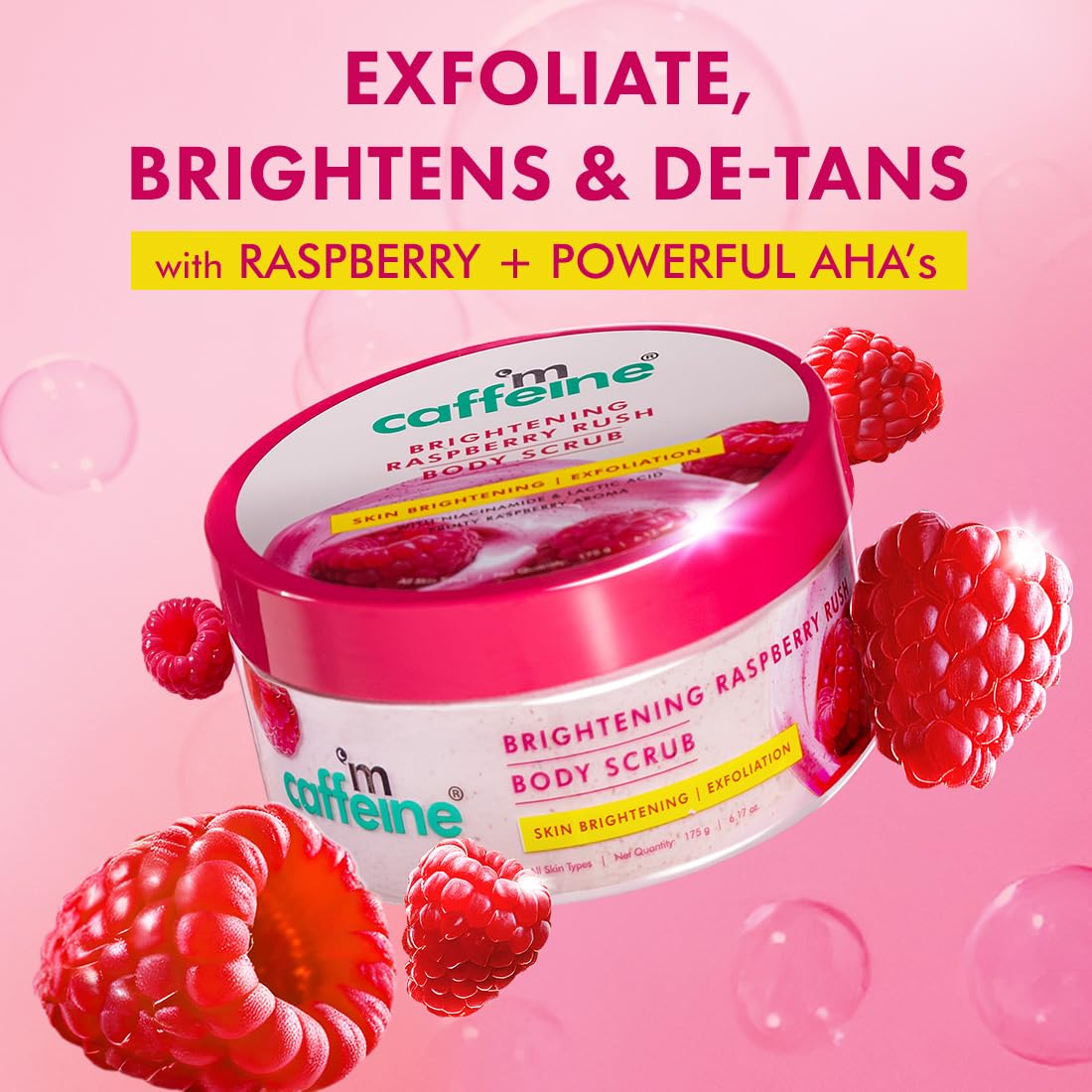 Caffeine brightening raspberry body scrub with raspberries on a pink background