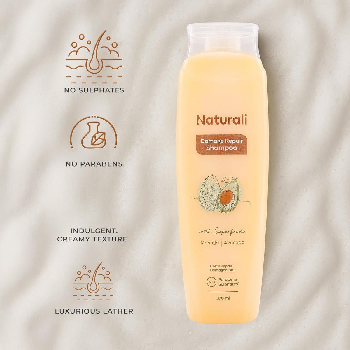 Naturali Damage Repair Shampoo bottle with ingredients listed on a beige background