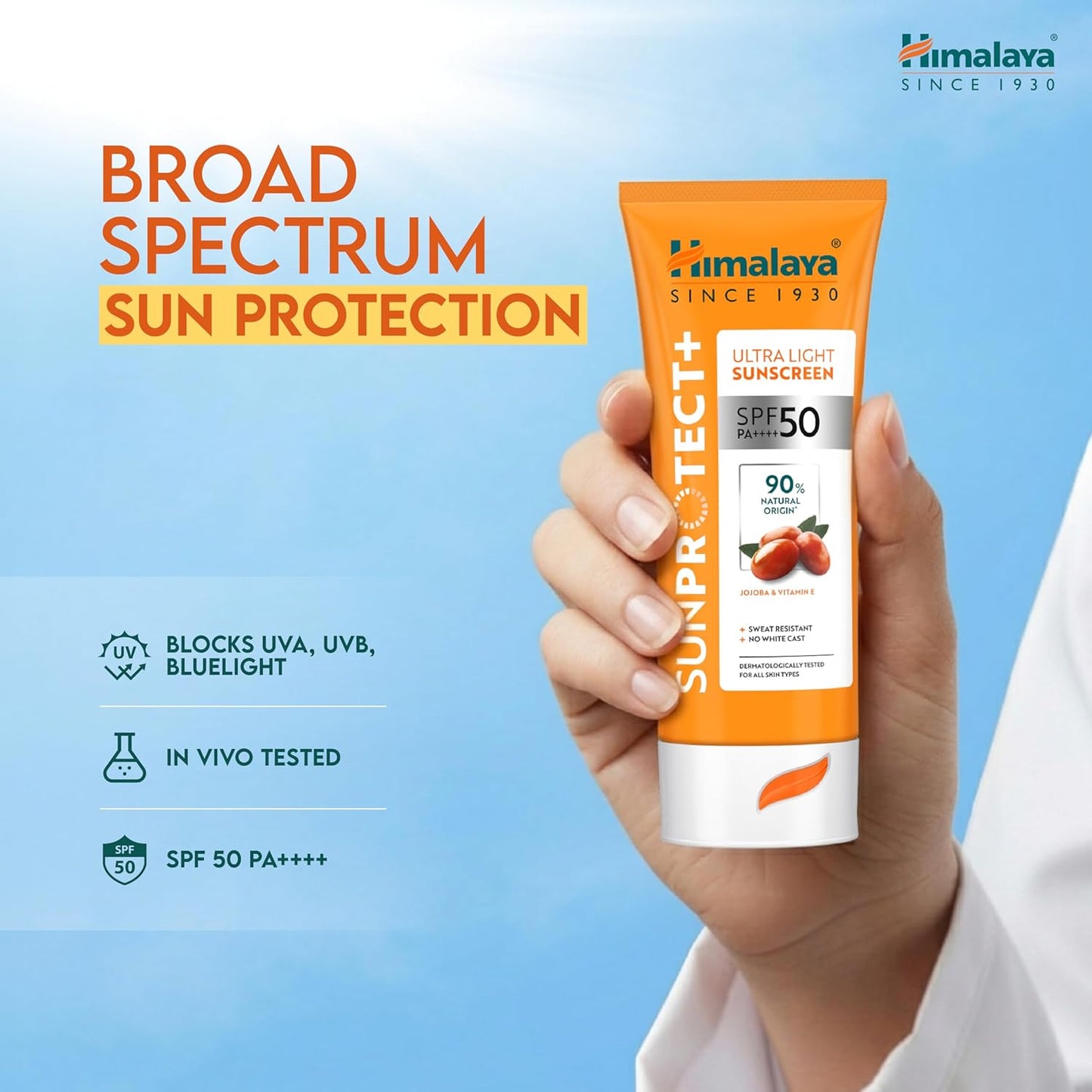 Himalaya Sun Protect+ sunscreen tube held in a hand with a blue background