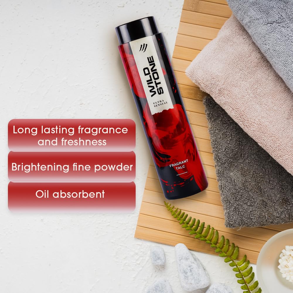 Red and black Wild Stone talcum powder bottle on a wooden board with towels and text highlighting product benefits.