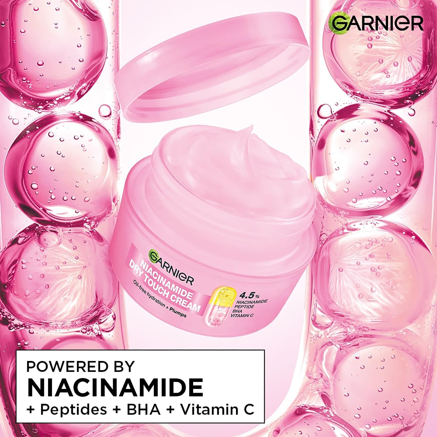 Garnier Niacinamide cream jar surrounded by pink bubbles on a white background