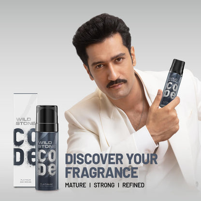 Man holding Wild Stone deodorant with product packaging on a gray background