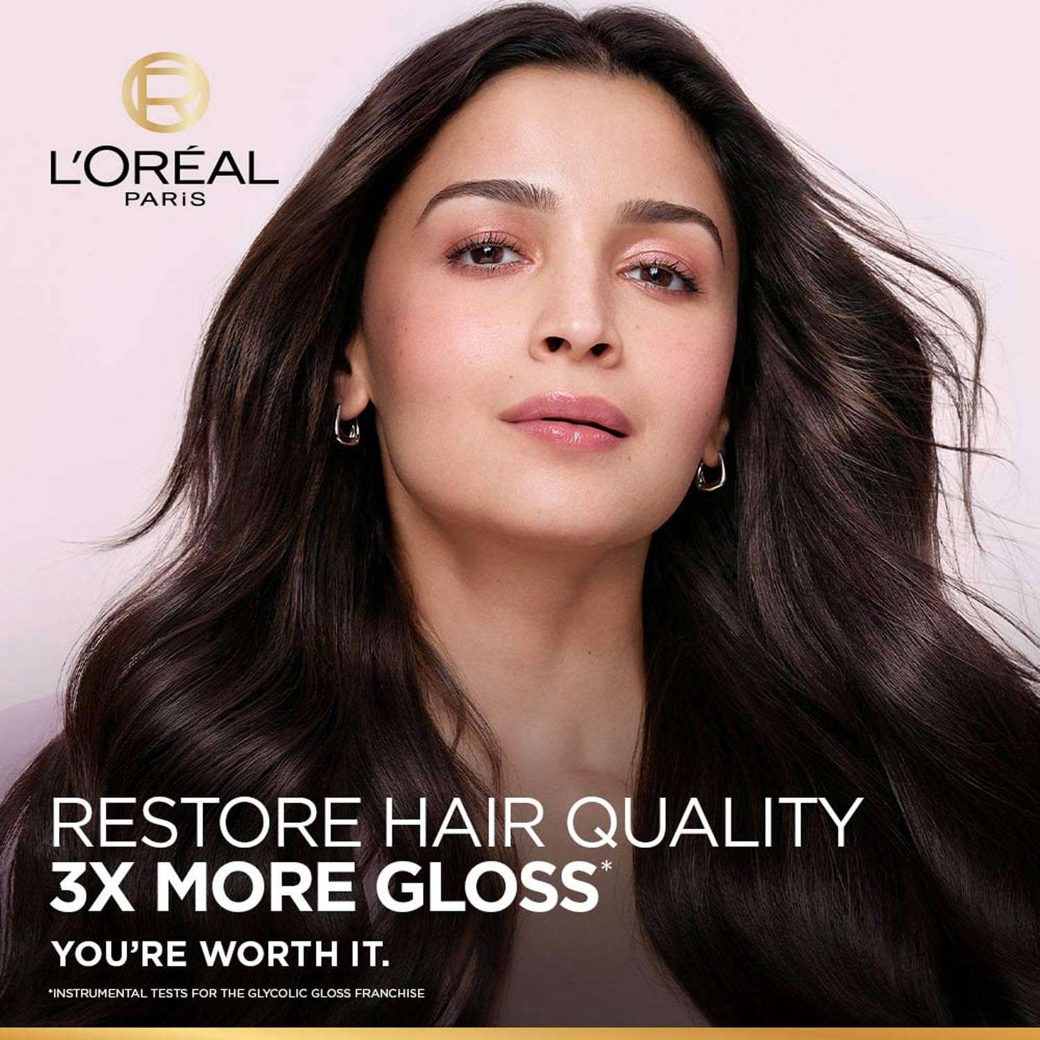 L'Oreal Paris advertisement with a woman with long, wavy hair and brand logo.