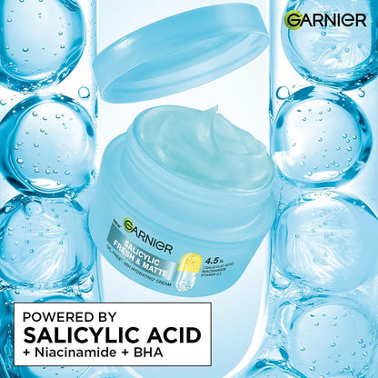 Garnier facial cream jar with salicylic acid ingredients on a blue bubble background