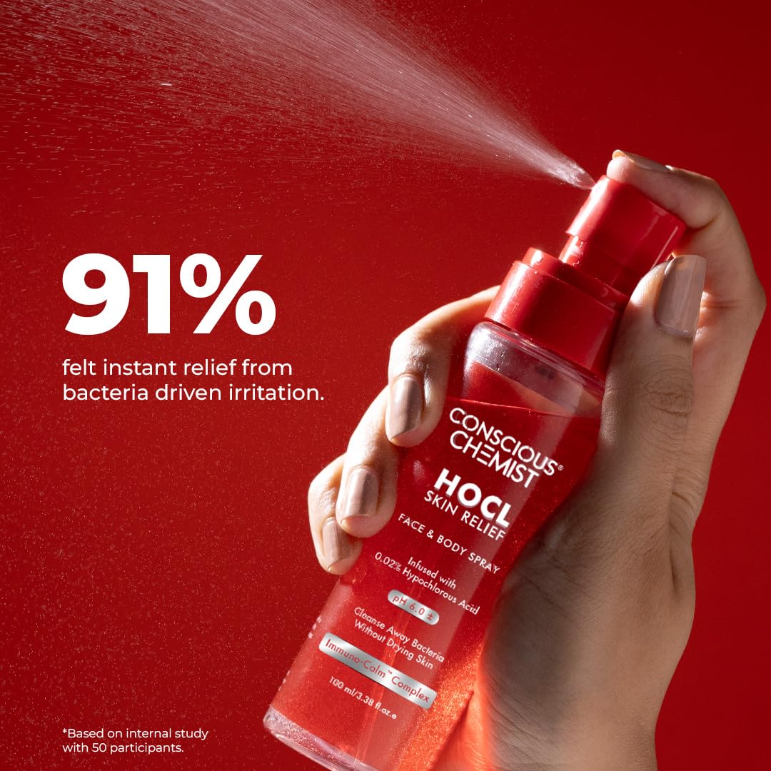 Hand holding a red spray bottle labeled 'Conscious Chemist HOCL Skin Relief' against a red background.
