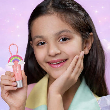 Young girl holding a pink lip balm with a rainbow design against a pink background