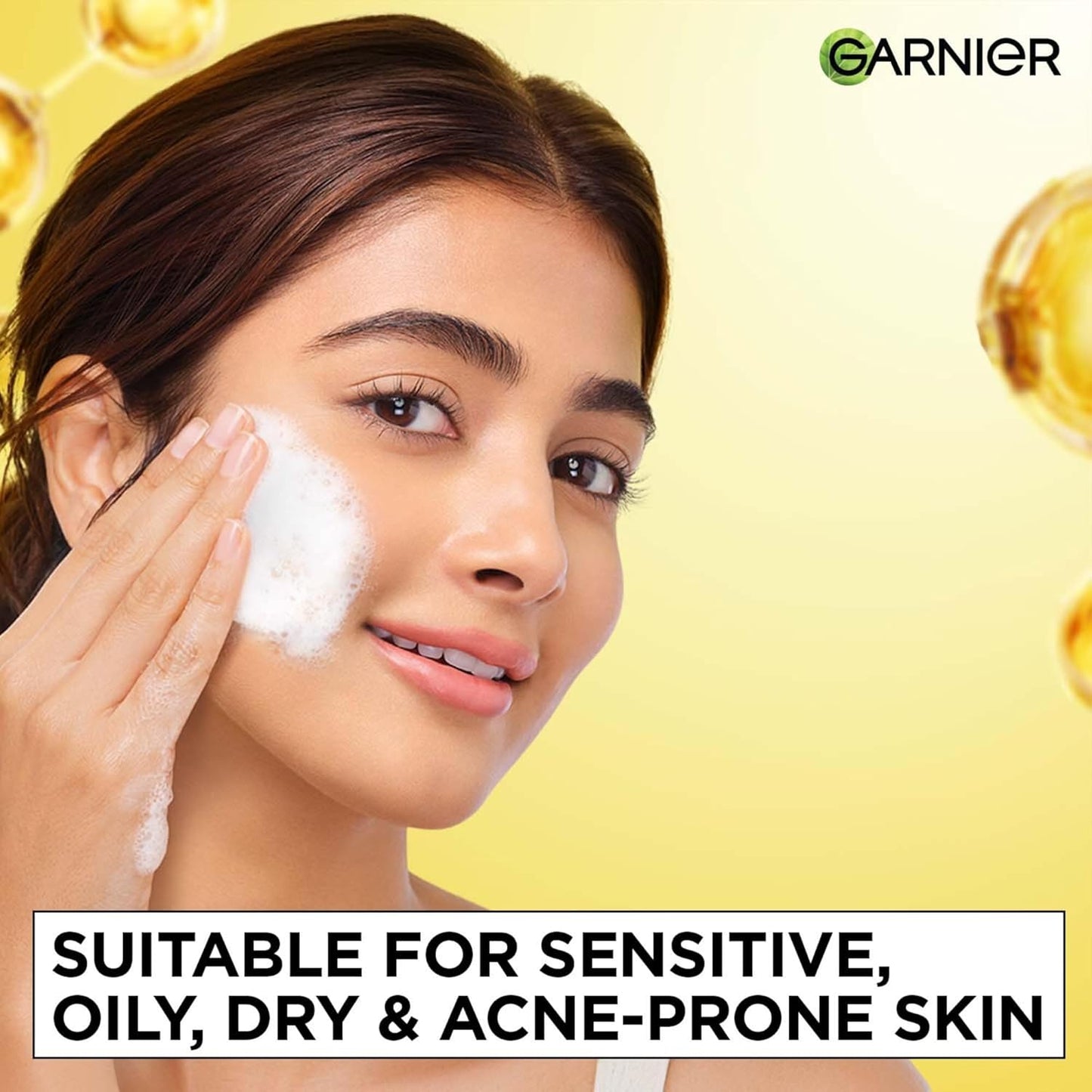Woman applying skincare product with Garnier logo on a yellow background
