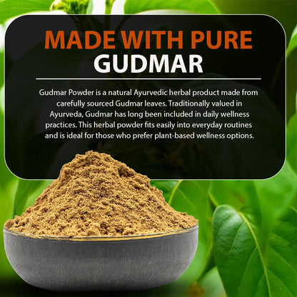 Bowl of Gudmar powder with green leaves in the background