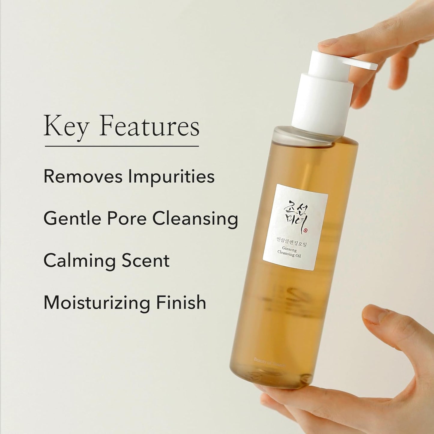 Bottle of skincare product with a hand holding it, labeled 'Key Features' on a light background.
