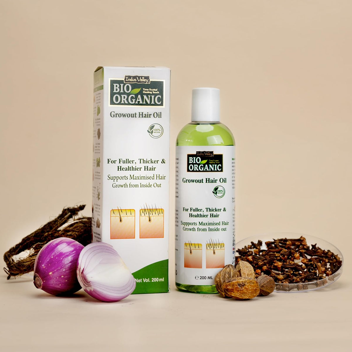 Bio Organic growout hair oil bottle and box with ingredients on a beige background
