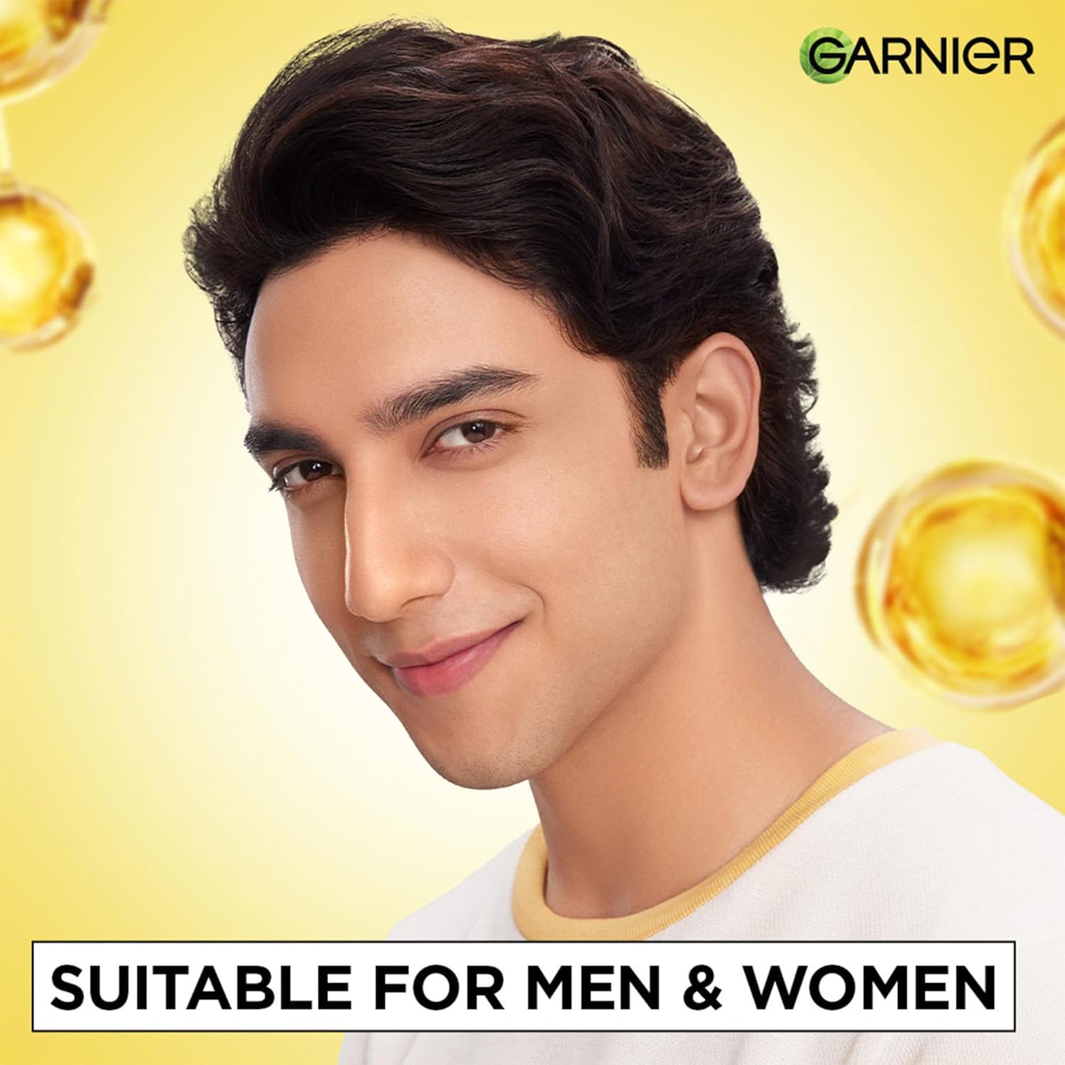 Person with styled hair against a yellow background with Garnier logo