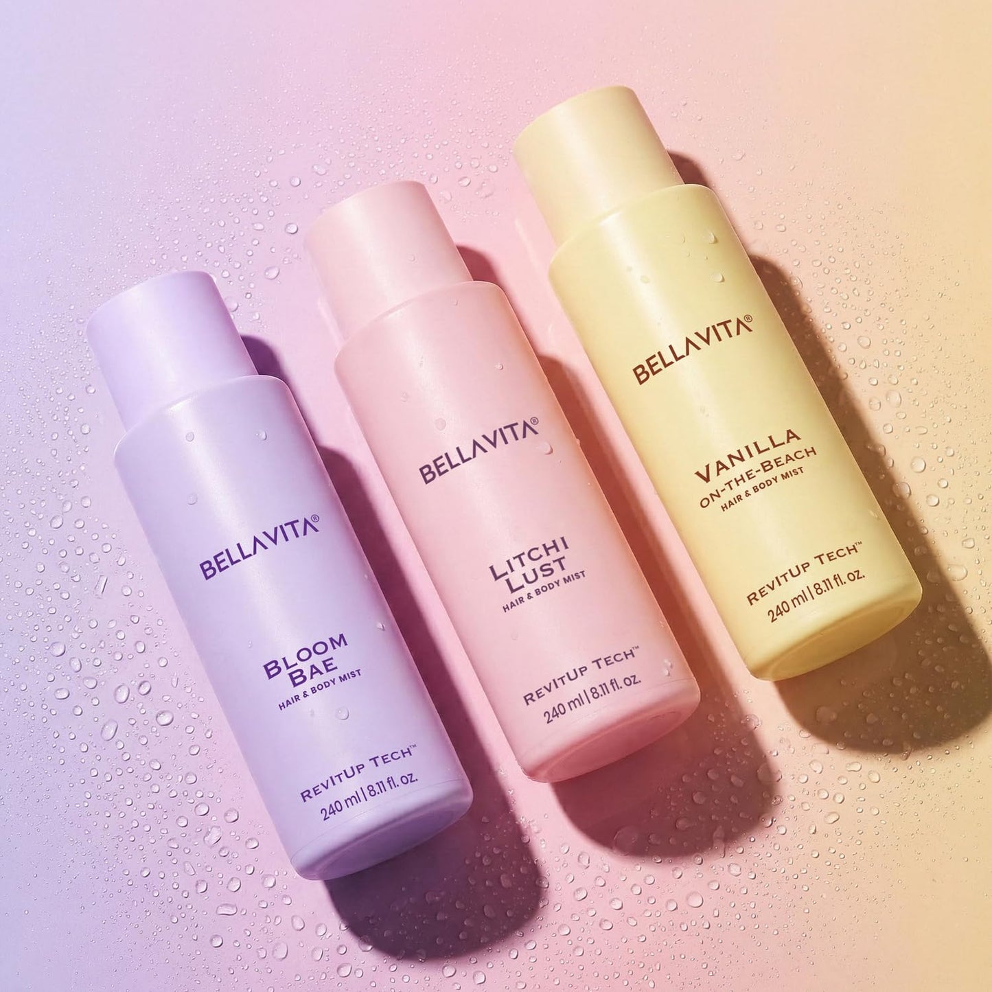 Three BellaVita hair and body mists on a gradient background