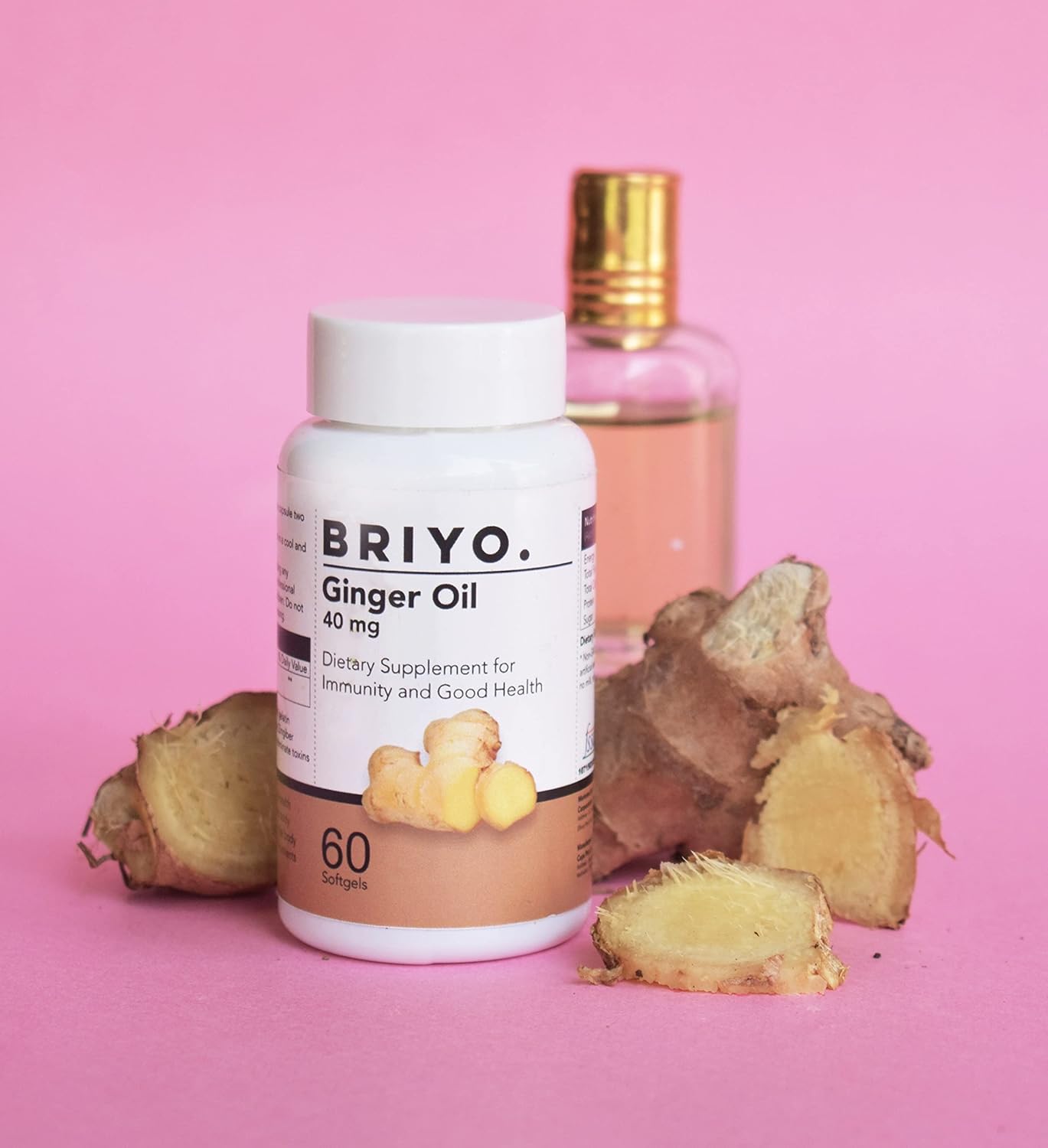 BRIYO Ginger Oil supplement bottle with ginger roots on a pink background