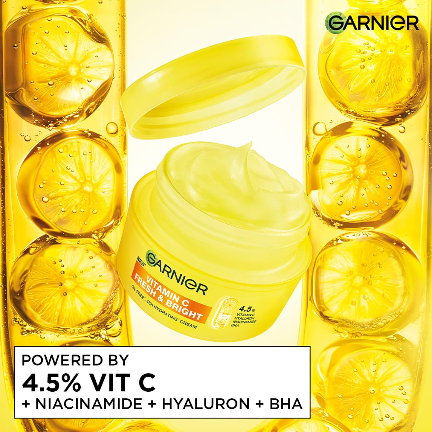 Garnier Vitamin C cream jar surrounded by lemon slices on a yellow background