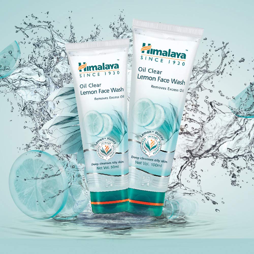Two tubes of Himalaya Oil Clear Lemon Face Wash with water droplets and a lemon slice on a light blue background.