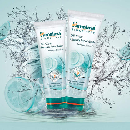 Two tubes of Himalaya Oil Clear Lemon Face Wash with water droplets and a lemon slice on a light blue background.
