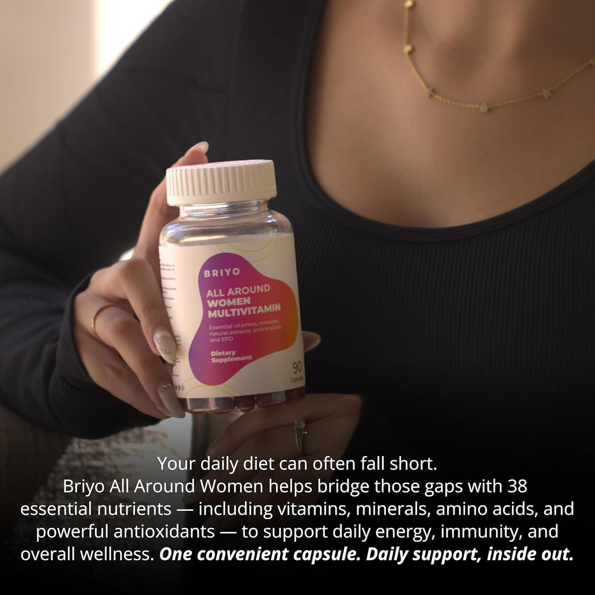 Person holding a bottle of Briyo All Around Women Multivitamin with text about daily support.