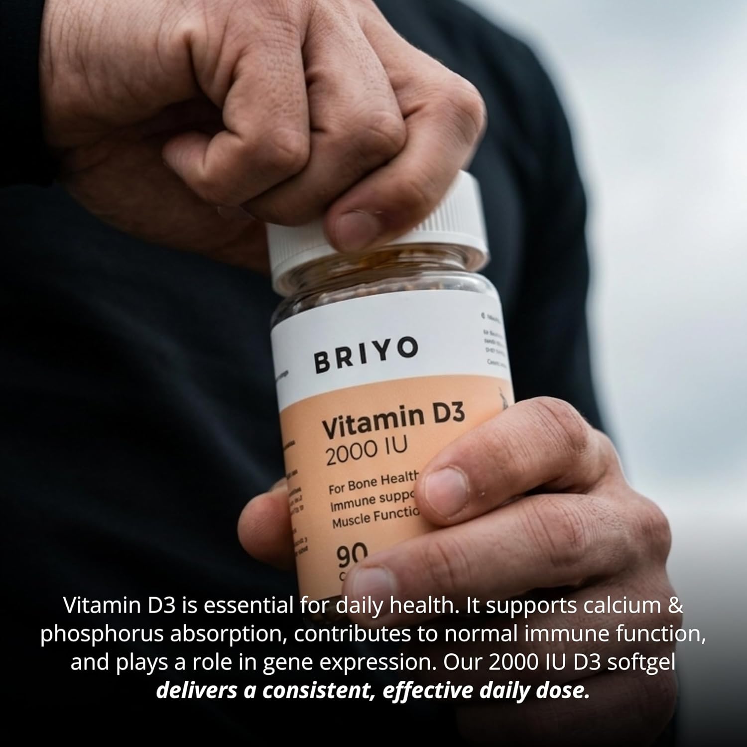 Hand holding a bottle of Briyo Vitamin D3 supplement with text about its benefits.