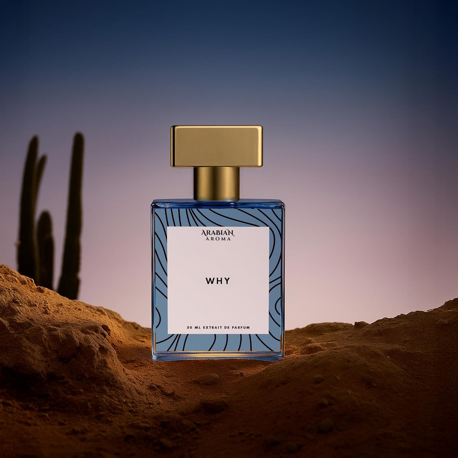 Perfume bottle labeled 'Why' by Arabian Oudh in a desert setting