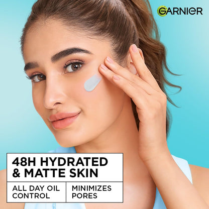 Woman applying skincare product with Garnier logo on a blue background